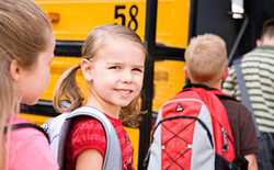 Young students boarding the school bus